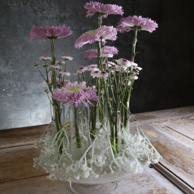 Pink chrysanthemums in a candle waxed arrangement